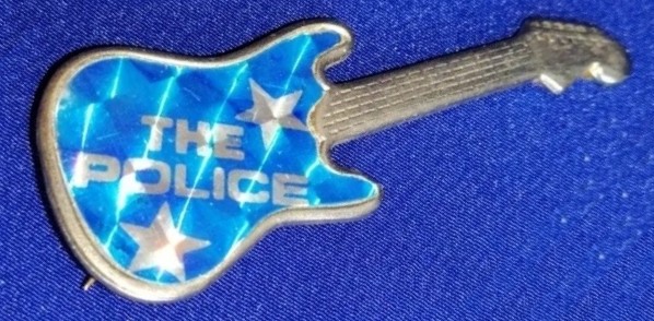 File:Guitar Police metal badge light blue stars glitter Miquel Martinez.jpg