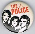 1979 08 Police white background red letters star round button.jpg