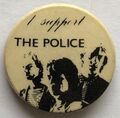 1979 09 Police fin costello beige background round button.jpg