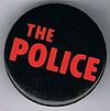 The Police round button original logo red on black.jpg