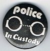 Police In Custody black white letters round.jpg