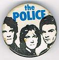 1979 08 Police white background blue letters round button.jpg