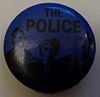 1979 09 Police fin costello black blue round button Toni Carbo.jpg