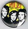 1979 08 Police yellow background red letters glitter round button.jpg