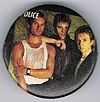 1983 Synchronicity photo shoot larger black green round button.jpg