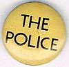 The Police small round button thin logo on beige.jpg