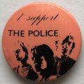 1979 09 Police fin costello salmon background round button.jpg