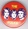 1979 08 Police red background purple faces round button.jpg