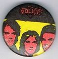 1979 08 Police black yellow round button.jpg