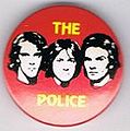 1979 08 Police red background black faces round button.jpg